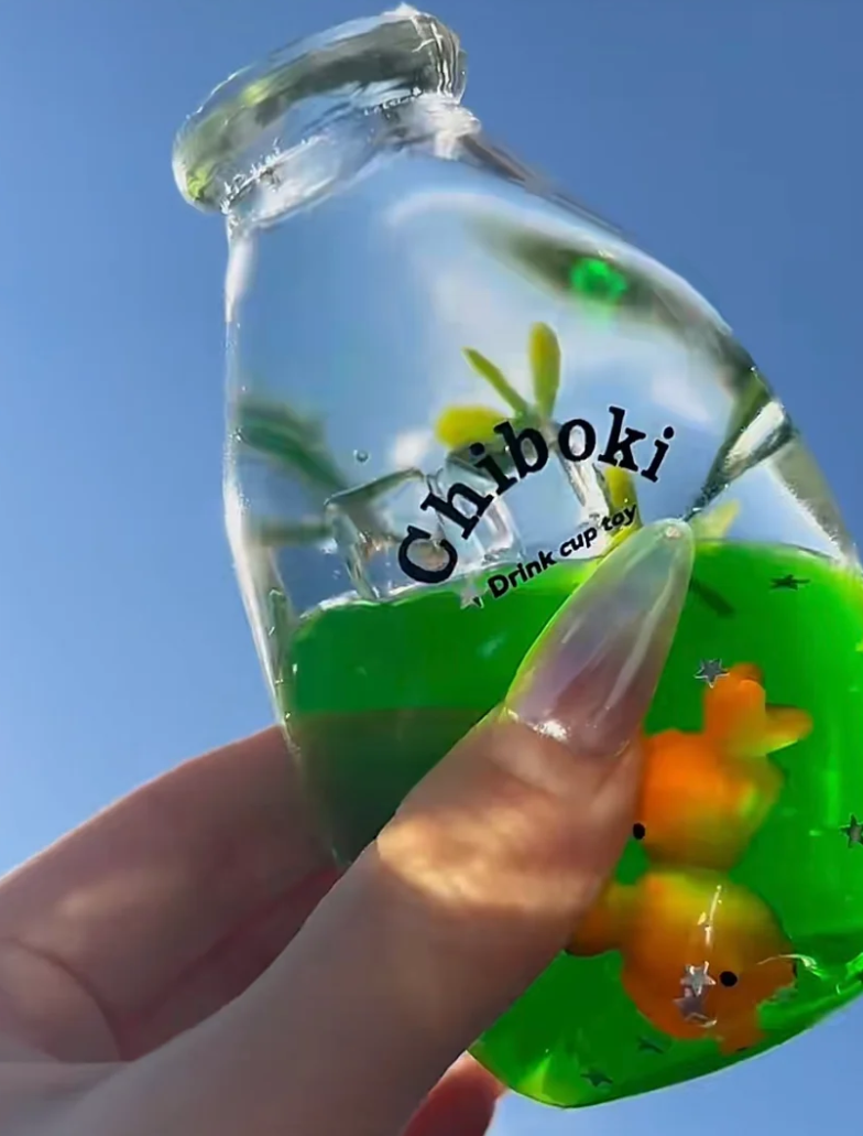 Green drink bottle squishy toy with a duck charm